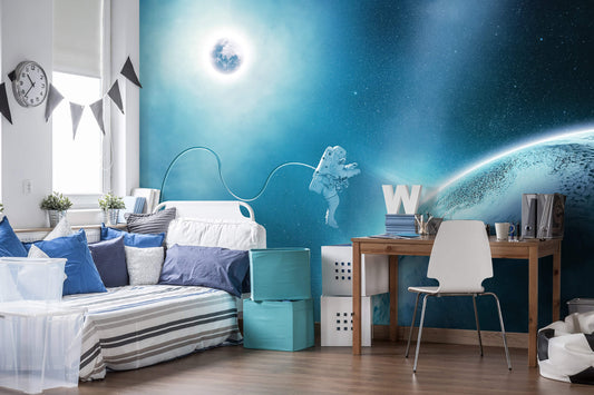 A room with blue wallpaper featuring a cosmic space walk and astronomy theme, including a depiction of a planet and stars.
