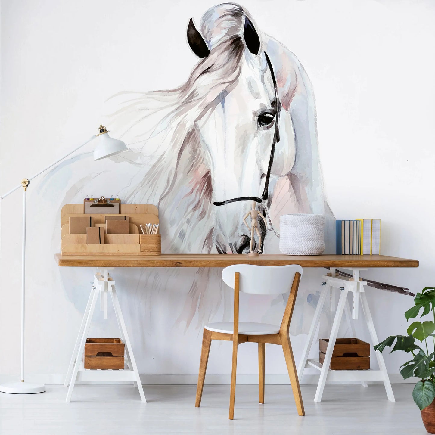 White horse mural on a wall above a wooden desk with office supplies.