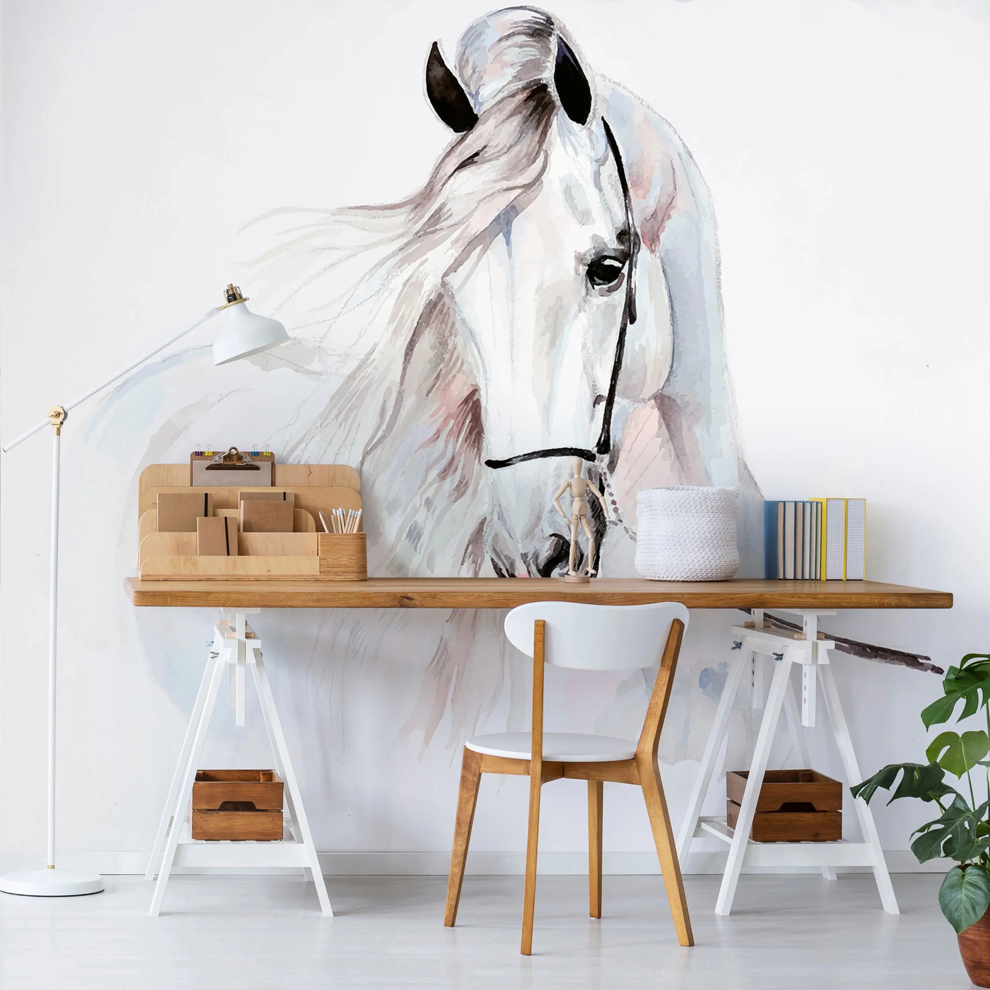 White horse mural on a wall above a wooden desk with office supplies.