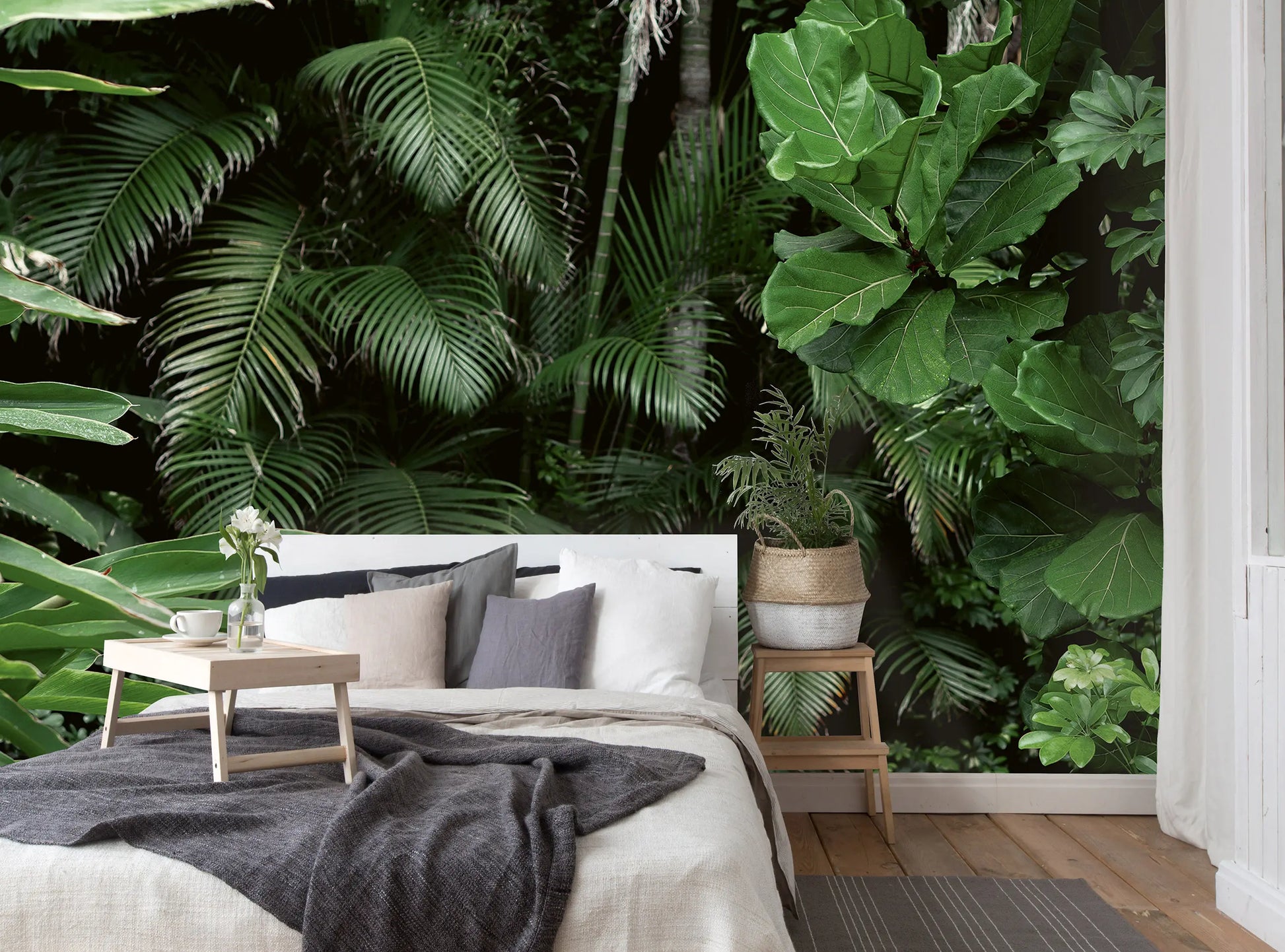 Modern bedroom with tropical plants and a large window