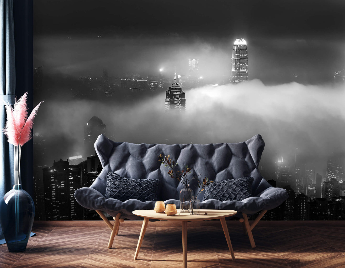 A cozy room with a black sofa in front of a wall featuring a black and white city skyline in the fog non-woven photo wallpaper.