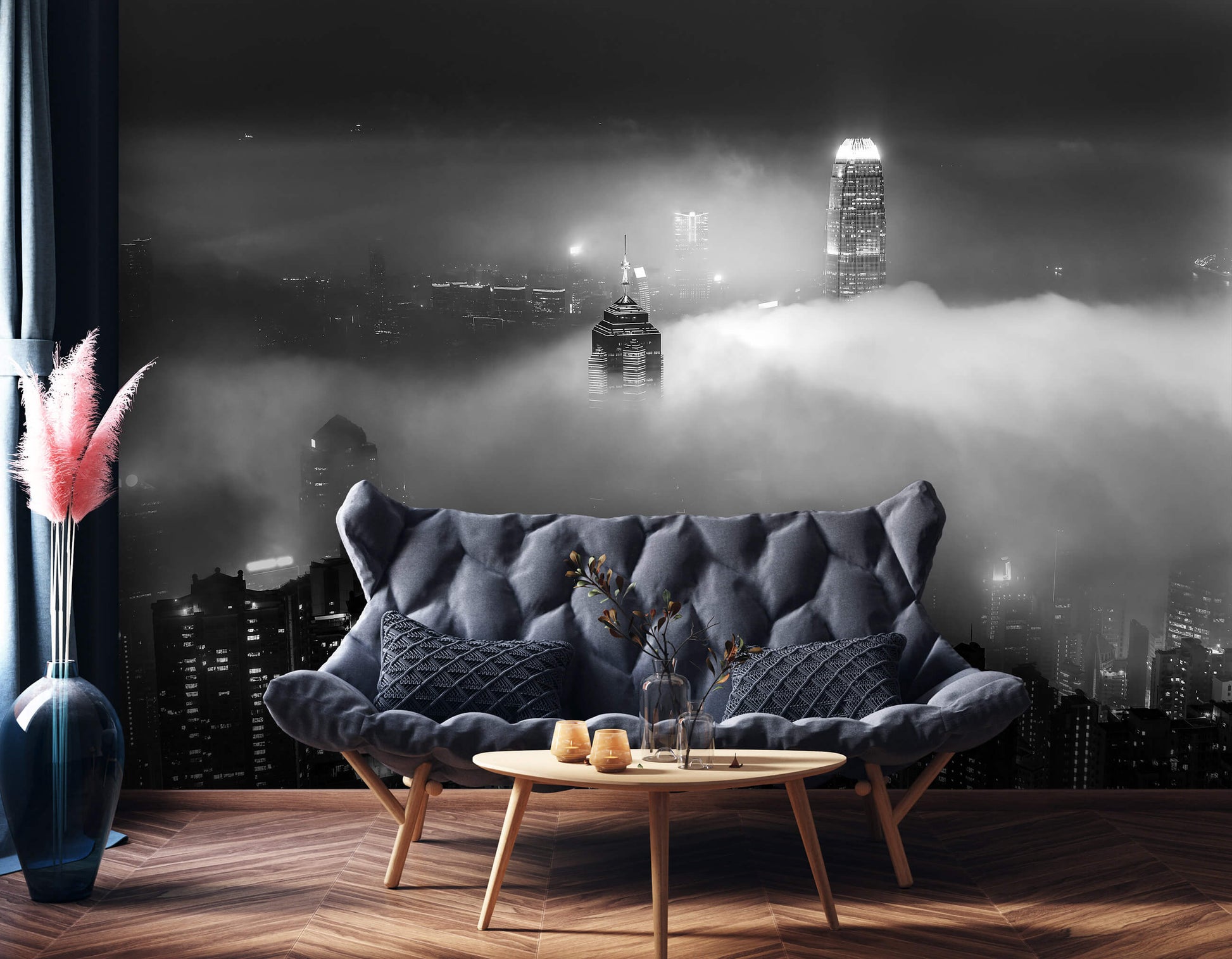 A cozy room with a black sofa in front of a wall featuring a black and white city skyline in the fog non-woven photo wallpaper.