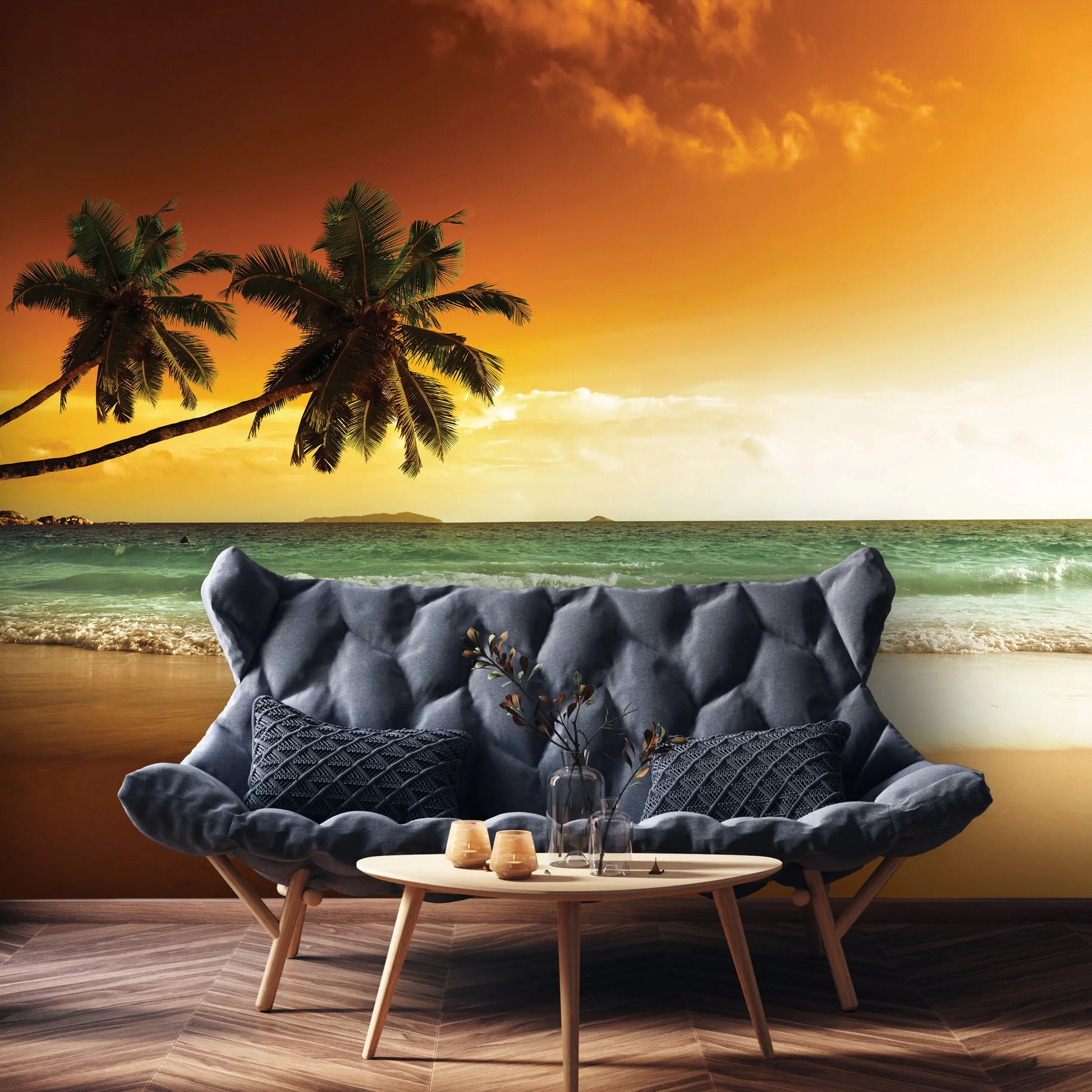 Blue sofa with a coffee table against a beach backdrop with palm trees and sunset.
