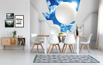 A photo wallpaper featuring a 3D abstract composition of spheres in various sizes, installed on a wall above a dining area with white chairs and a wooden table.
