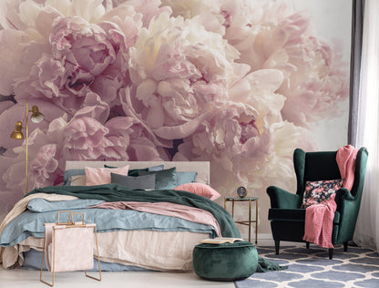Decorative bedroom with floral wall mural, bed, and armchair.