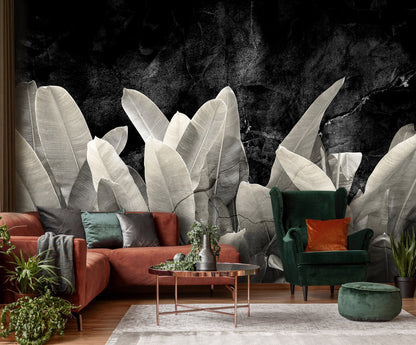 Modern living room with a sofa, armchair, and coffee table against a decorative wall with plant-like patterns.