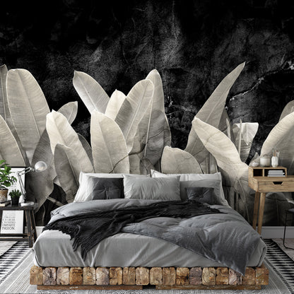 Bedroom with large leafy plant mural on the wall
