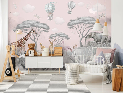 Children's room with pink wall mural, furniture, and toys.