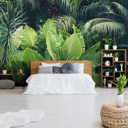 Modern bedroom with tropical leaf wallpaper and wooden furniture