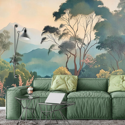 Green sofa with decorative pillows in a room with nature-themed wall mural.