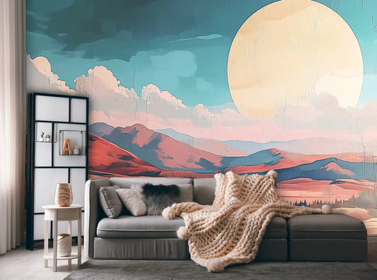 Living room with a large wall mural of mountains and a sun, featuring a gray sofa and decorative pillows.