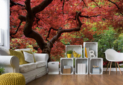 Living room with a large wall mural of a tree with red leaves.