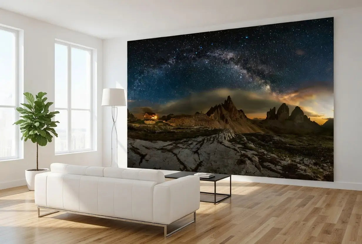 Living room with a large wall mural of a mountain landscape and night sky.