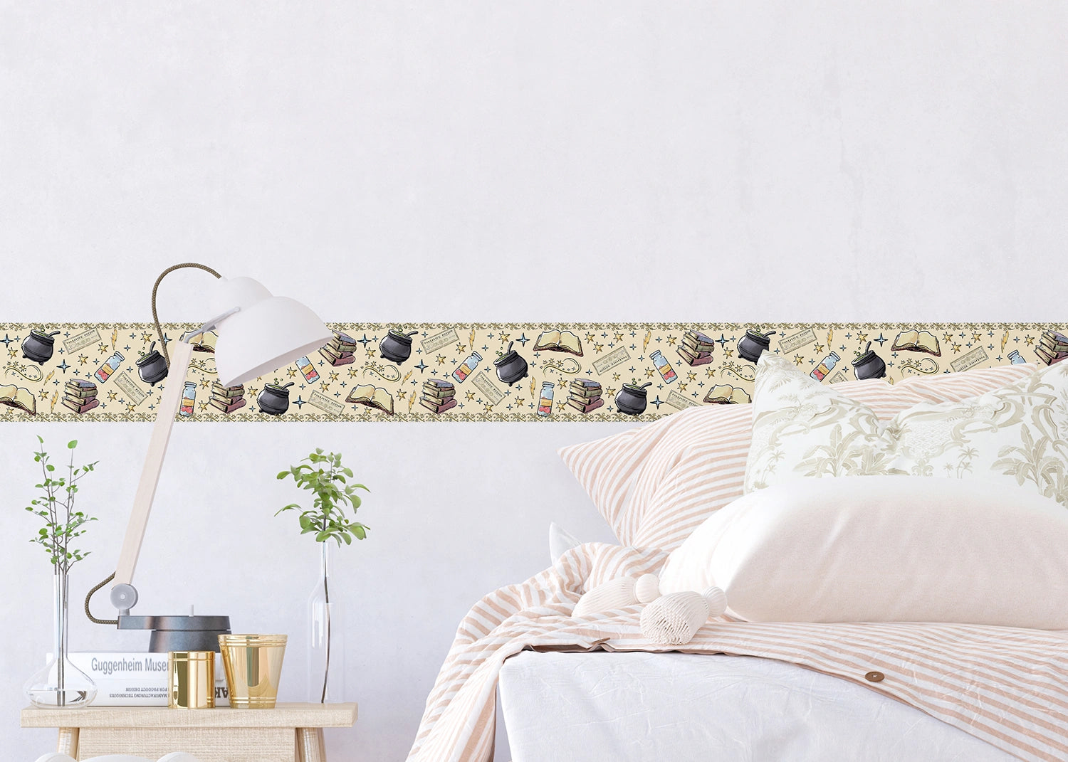 Decorative border with vintage-style illustrations above a bed in a bedroom setting.